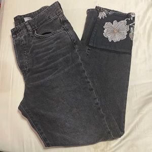 Faded black jeans with floral hems